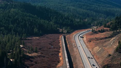 Aerial-view-of-BNSF-Railway-train-traveling-along-a-highway