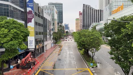 Point-of-view-of-the-wet-road-leading-to-New-Bridge-Road-next-to-Clarke-Quay-Central,-a-shopping-district-in-Singapore