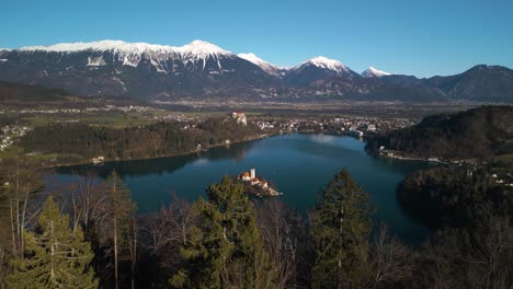 Slow-Cinematic-Establishing-Drone-Shot-Above-Lake-Bled,-Slovenia
