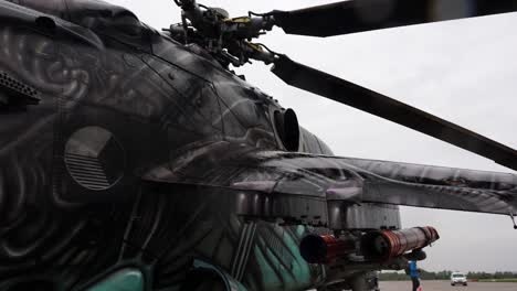 Walk-near-colorful-Mil-Mi-24-attack-helicopter-with-missiles-attached-on-wing