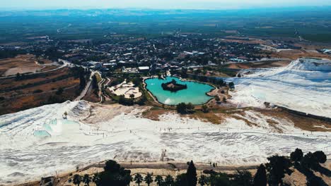 Aerial-4K-drone-video-of-a-tourist-attraction-Pamukkale,-natural-pool-with-blue-water,-Turkey-Calcareous-minerals