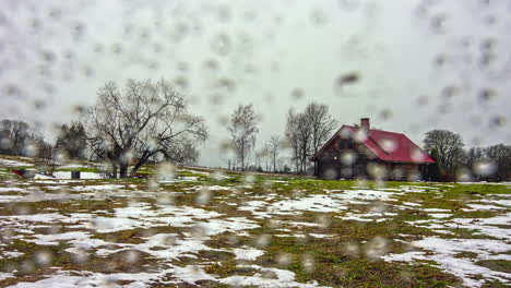 Cabin-in-a-field-on-a-day-with-rain-and-sleet---time-lapse