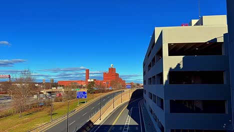A-Time-lapse-by-Route-9-near-the-Anheuser-Busch-Co-plant-in-Newark,-NJ-on-a-sunny-day-with-blue-skies