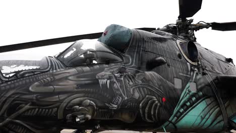 Parked-Mil-Mi-24-helicopter-artistic-exterior-design-at-airport-field