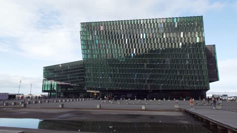 Crowd-of-people-in-front-of-the-concert-hall-and-conference-centre-Harpa-in-Reykjavík,-Iceland