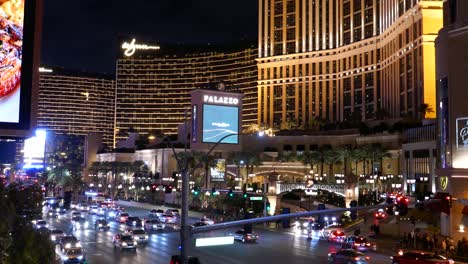 An-evening-shot-of-the-Palazzo-and-Wynn-resorts-in-Las-Vegas,-with-busy-traffic-and-bright-hotel-facades