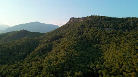 Aerial-4K-drone-footage-of-a-hill-with-the-Turkey-flag-waving-about-the-city-of
Kemer