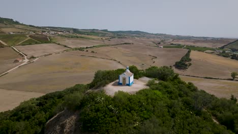 Aerial-shot-of-ancient-chapel-of-Nossa-Senhora-do-Monte-in-Arruda-dos-Vinhos-in-Portugal