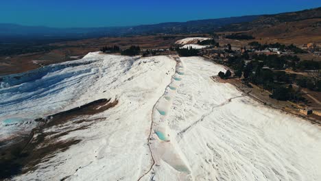 Aerial-4K-drone-video-of-a-tourist-attraction-Pamukkale,-natural-pool-with-blue-water,-Turkey-Calcareous-minerals