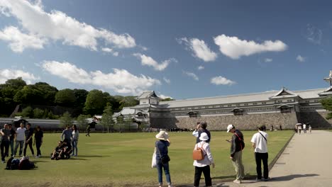 Visitors-And-Tourists-Taking-Photos-From-Corner-Of-Park-Garden-In-Front-Of-Gojukken-Nagaya-On-Sunny-Afternoon-Day