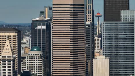 Drone-shot-of-the-Space-Needle-peaking-through-skyscrapers-in-Seattle