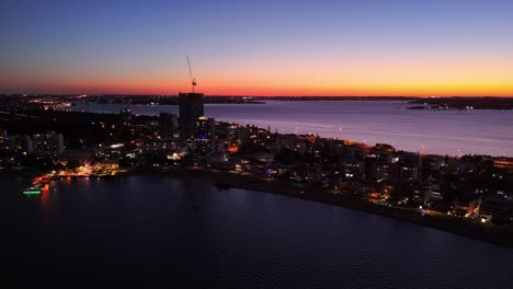 Sun-setting-over-the-South-Perth-skyline-with-lights-glistening