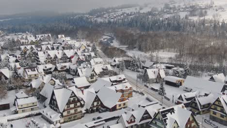 Bialy-Dunajec-traditional-polish-mountain-village-covered-in-snow,-aerial-winter-landscape