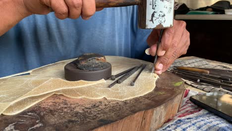 Indonesian-elderly-man-making-carving-hand-made-wayang-shadow-puppet