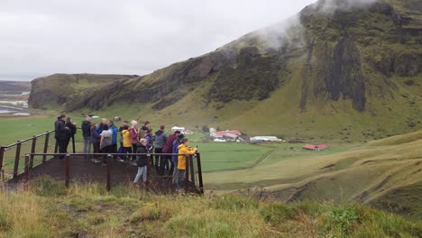 Tourists-hiked-up-the-mountain-stairs-to-a-viewing-platform-overlooking-the-Skogafoss-waterfall-in-Iceland