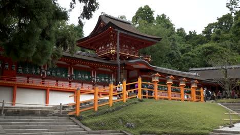 Exterior-View-Of-Kasuga-Taisha-Shrine-With-Tourists-Walking-Past