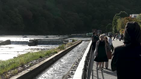Tourists-Taking-Photos-Beside-Kadono-Oi-In-Arashiyama,-Kyoto