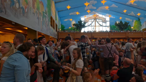 People-Partying,-Drinking,-Dancing,-in-Beer-Tent-at-Oktoberfest