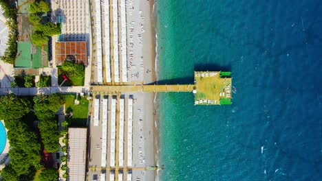 Aerial-4K-drone-wide-top-down-video-of-a-wooden-pier-near-hotel-resort-in-the-city-of-Kiriş---Kemer