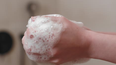 Shower-Exfoliate-Bath-Sponge-In-The-Hands-Of-A-Woman