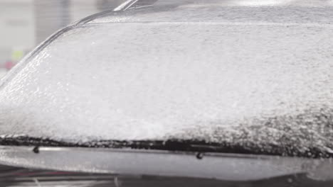 Slow-Motion-Car-Wash-with-Spray-Foam-Soap-applying-on-car-wind-shield