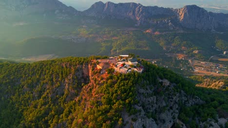 Aerial-4K-drone-video-of-a-Tunektepe-Teleferik
Cable-station-positioned-on-top-of-the-hill-with-the-mountains-in-the-background