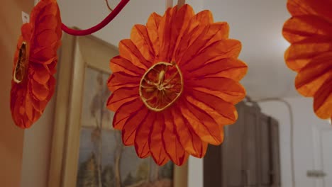 String-of-Holiday-Decorations:-Bells,-Paper-Flowers,-Dried-Oranges