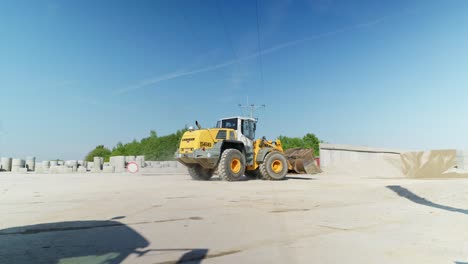 Heavy-wheel-loader-drive-on-construction-site-to-transport-building-materials