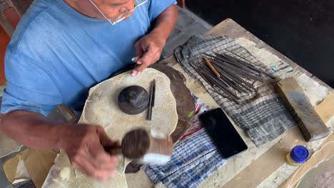 Yogyakarta,-Indonesia---Dec-16,-2023-:-Indonesian-man-making-wayang-shadow-puppet