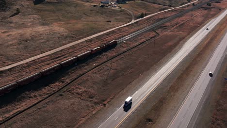 Panning-down-drone-shot-of-BNSF-Railway-Train-while-moving