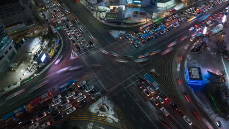 Gangnam-Station-Crossroad-Massive-Busy-Bustling-Night-Cars-Traffic-Time-Lapse-in-Seoul-Main-Street---Top-Down-View-Zoom-Out
