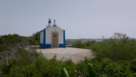 Aerial-drone-180º-shot-with-bushes-of-ancient-chapel-of-Nossa-Senhora-do-Monte-in-Arruda-dos-Vinhos-in-Portugal