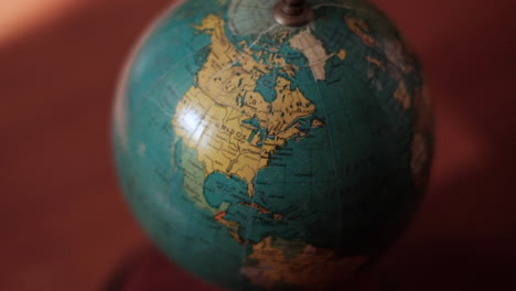 Vintage-globe-with-focus-on-North-America-in-warm-light,-Canada,-USA,-Mexico-regions