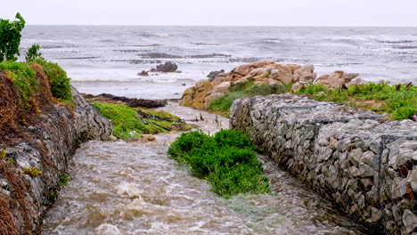 Gabion-walls-to-prevent-soil-erosion-as-rainwater-runs-down-into-ocean-on-coast
