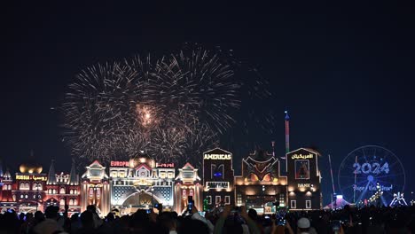 January-1,-2024,-People-watching-New-Year-2024-fireworks-at-Global-Village-in-Dubai,-United-Arab-Emirates