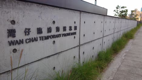Wan-Chai-Temporary-Promenade-Sign-On-Stone-Wall-Beside-Pavement