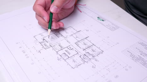 An-individual-checking-the-draft-of-an-architectural-flor-plan-of-a-proposed-building