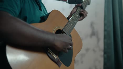 Detail-Shot-of-Unrecognizable-Black-Man-Playing-Acoustic-Guitar