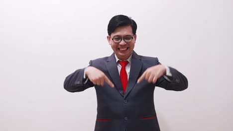 Happy-asian-businessman-pointing-above-and-down-then-showing-thumbs-up-okay-hand-gesture