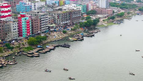 A-high-angle-shot-of-small-boats-on-the-Buriganga-River-by-Dhaka's-bustling-riverfront