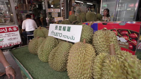 Durian-on-Display-at-Street-Food-Vendor-in-Chinatown,-Bangkok,-Thailand
