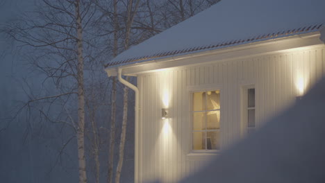 Outdoor-light-lamps-on-house-exterior-in-snowy-winter-weather