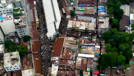 Aerial-close-up-view-of-slum-and-then-shot-moves-to-Dhaka,-Bangladesh's-cityscape