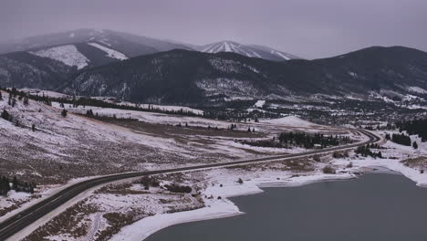 Lake-Dillon-Keystone-Summit-cove-highway-Colorado-aerial-cinematic-drone-cloudy-snowy-winter-morning-view-Frisco-Breckenridge-Silverthorne-Ten-Mile-Range-peaceful-calm-frozen-ice-forward-reveal