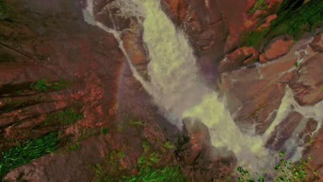 A-zoom-out-of-Bijagual-waterfall-with-rocks-and-prismatic-colors
