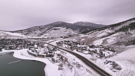 Lake-Dillon-Keystone-Summit-cove-car-highway-Colorado-aerial-cinematic-drone-cloudy-snowy-winter-morning-view-Frisco-Breckenridge-Silverthorne-Ten-Mile-Range-peaceful-calm-frozen-ice-forward-motion