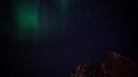 Northern-Lights-Aurora-Borealis-Displayed-in-Earth's-Sky-above-Mountain-Tops