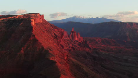 Aerial-cinematic-drone-Moab-Utah-dramatic-orange-sunset-mountain-snow-covered-peak-Big-Enchilada-landscape-Arches-National-Park-Castle-Valley-Castleton-Fishers-Tower-Green-River-camping-circle-right