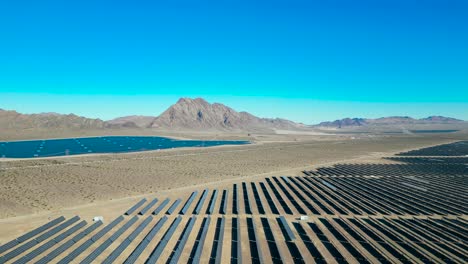An-vast-solar-farm-on-a-dry-lake-bed-with-mountains-overlooking-just-outside-of-Las-Vegas,-Nevada