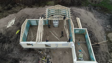 Aerial-time-lapse-of-workers-building-a-wooden-roof-frame-on-a-detached-house